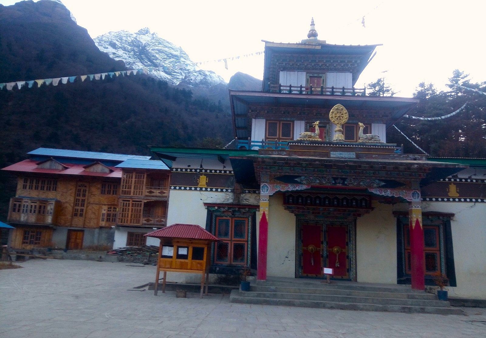 Buddhist monastery surrounded by Himalayan mountains along the Manaslu Circuit Trek trail.