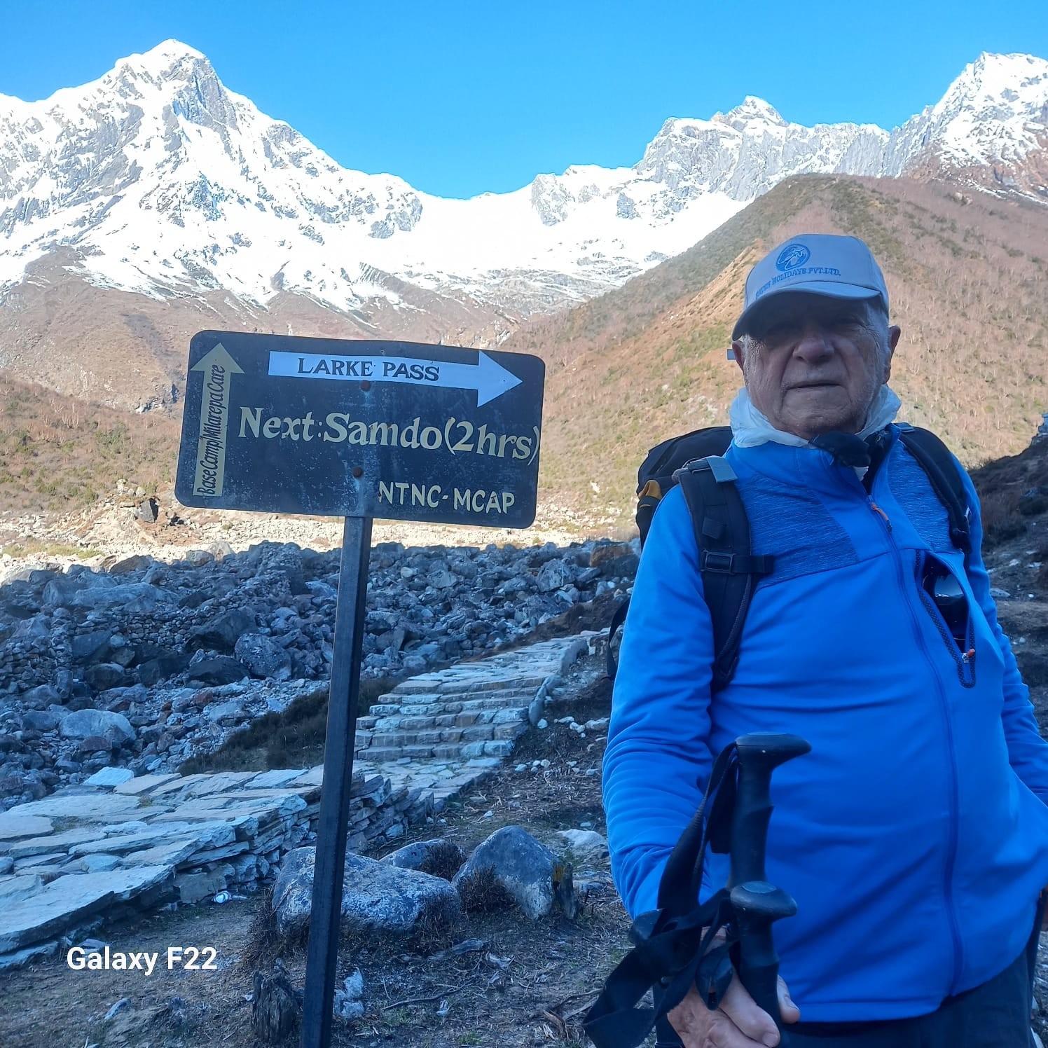 Trekker walking on mountain path toward Larke Pass