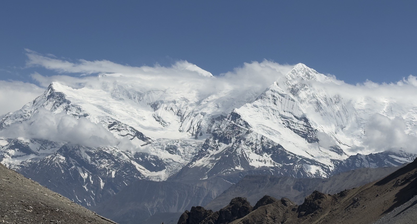  Panoramic view of the Annapurna mountain range from High Camp on the Annapurna Circuit Trek, featuring snow-capped Himalayan peaks, dramatic ridgelines, and expansive alpine landscapes under a clear mountain sky.