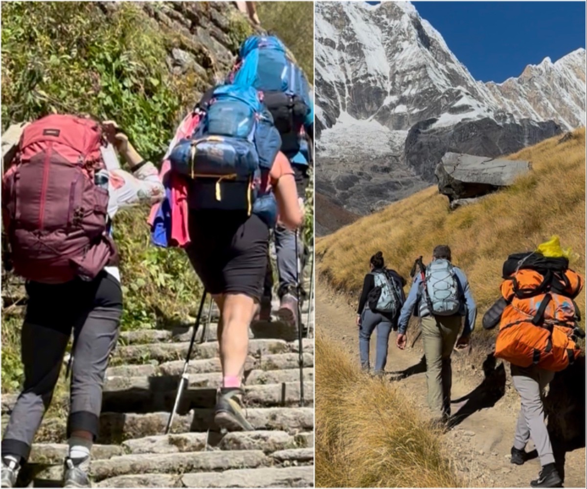 Independent trekker carrying heavy backpack and trekker with porter carrying light daypack on Annapurna Base Camp Trek Nepal