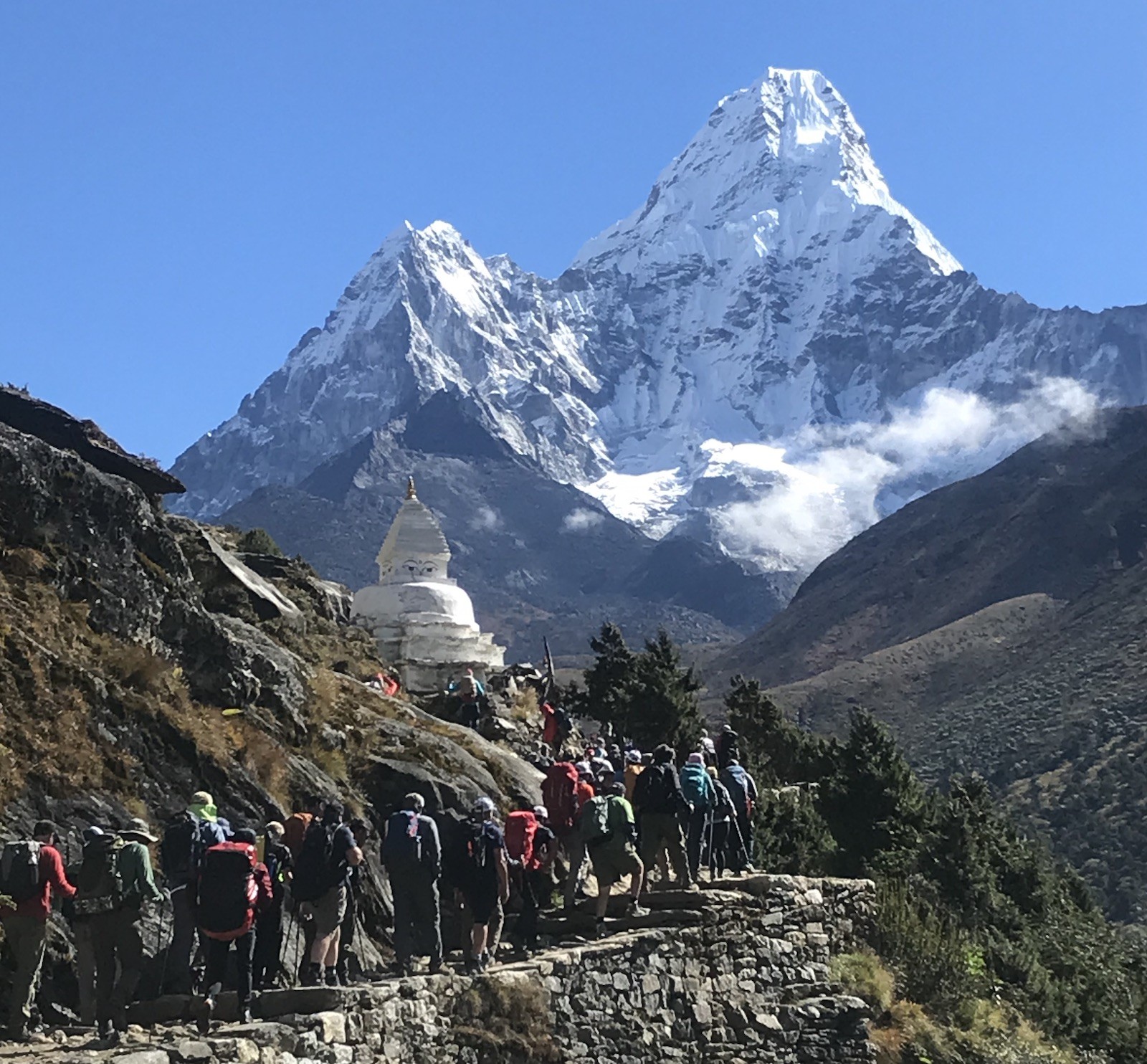 Crowded trekking trails in October on the way to Everest Base Camp with trekkers passing through busy Himalayan paths and views of Ama Dablam in the background.