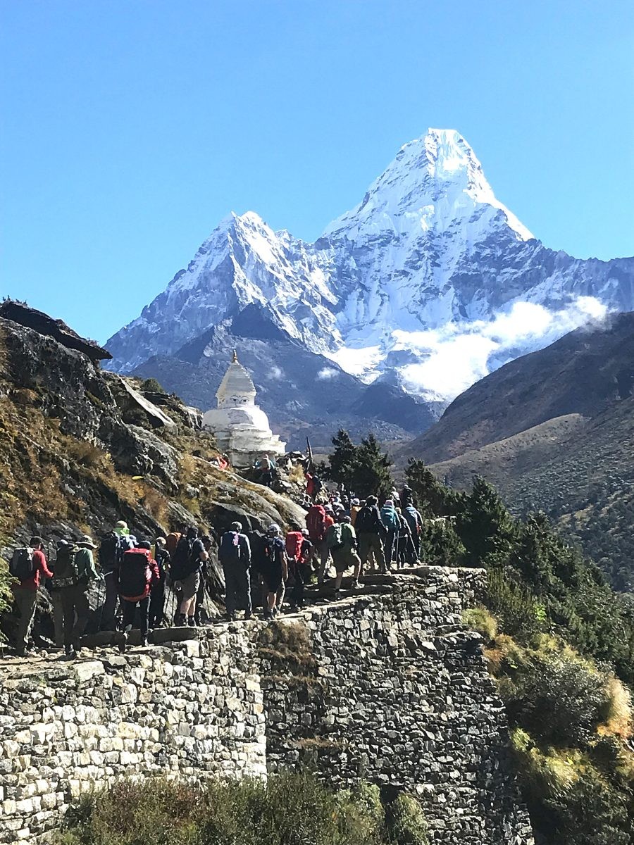 Trekkers crossing alpine terrain with Ama Dablam behind-Into Everest’s heart