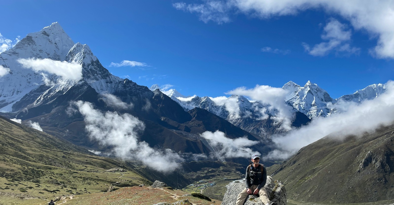September view of Pheriche with a few scattered clouds drifting above the valley, while the iconic peak of Ama Dablamrises dramatically in the background under crisp post-monsoon Himalayan skies.