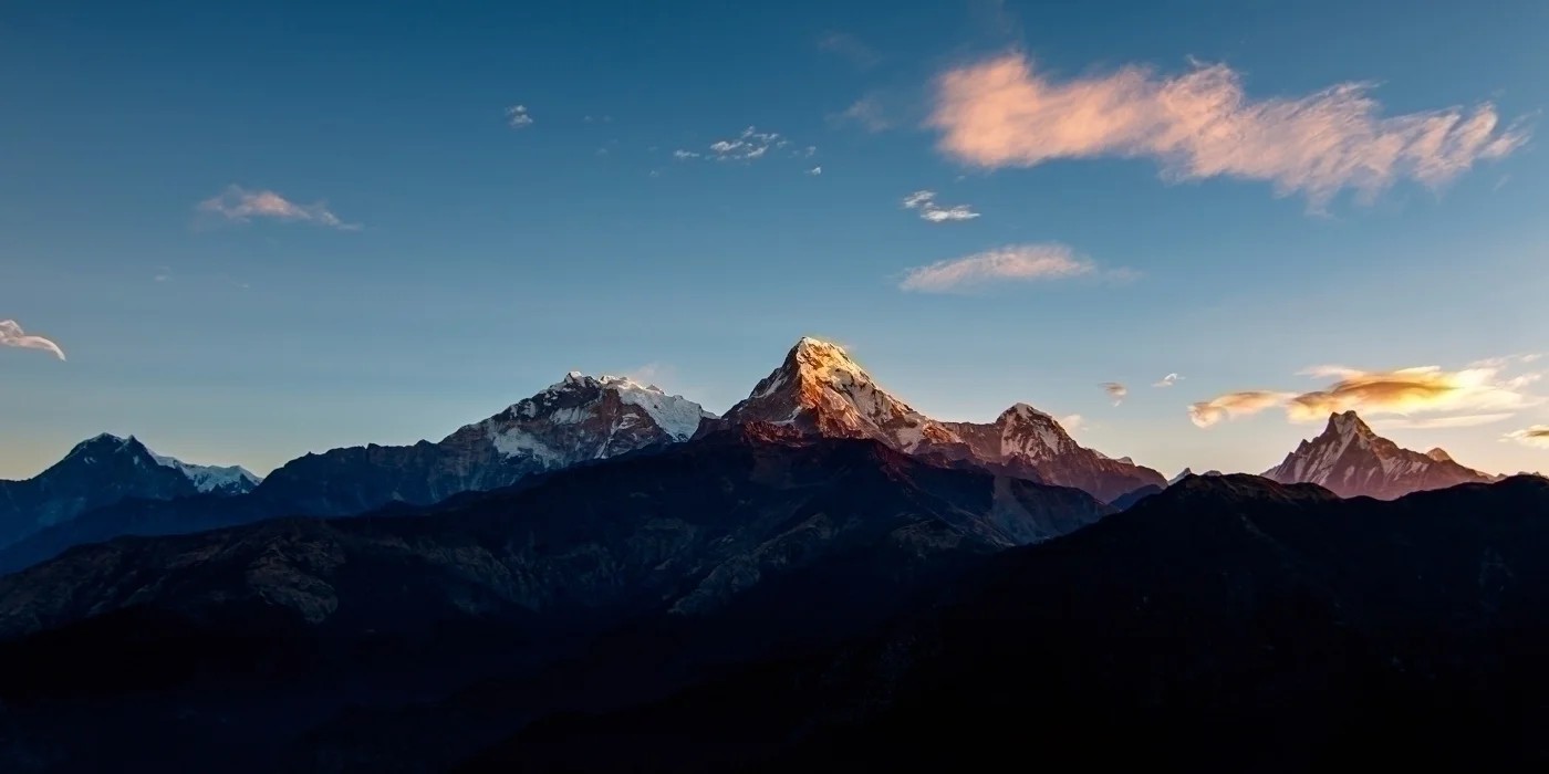 Trekkers watching the golden sunrise from Poon Hill with panoramic views of the Annapurna, Dhaulagiri, and Machhapuchhre (Fishtail) mountain ranges in Nepal.