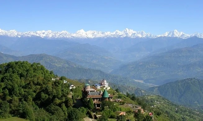 Scenic Himalayan view from Nagarkot with rolling hills and distant snow-capped mountains.