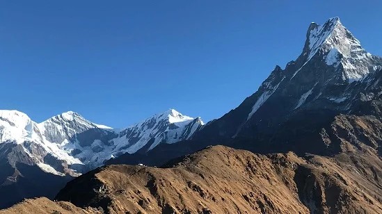 Trekkers enjoying panoramic views of the Annapurna range from a scenic viewpoint on the Mardi Himal Trek.