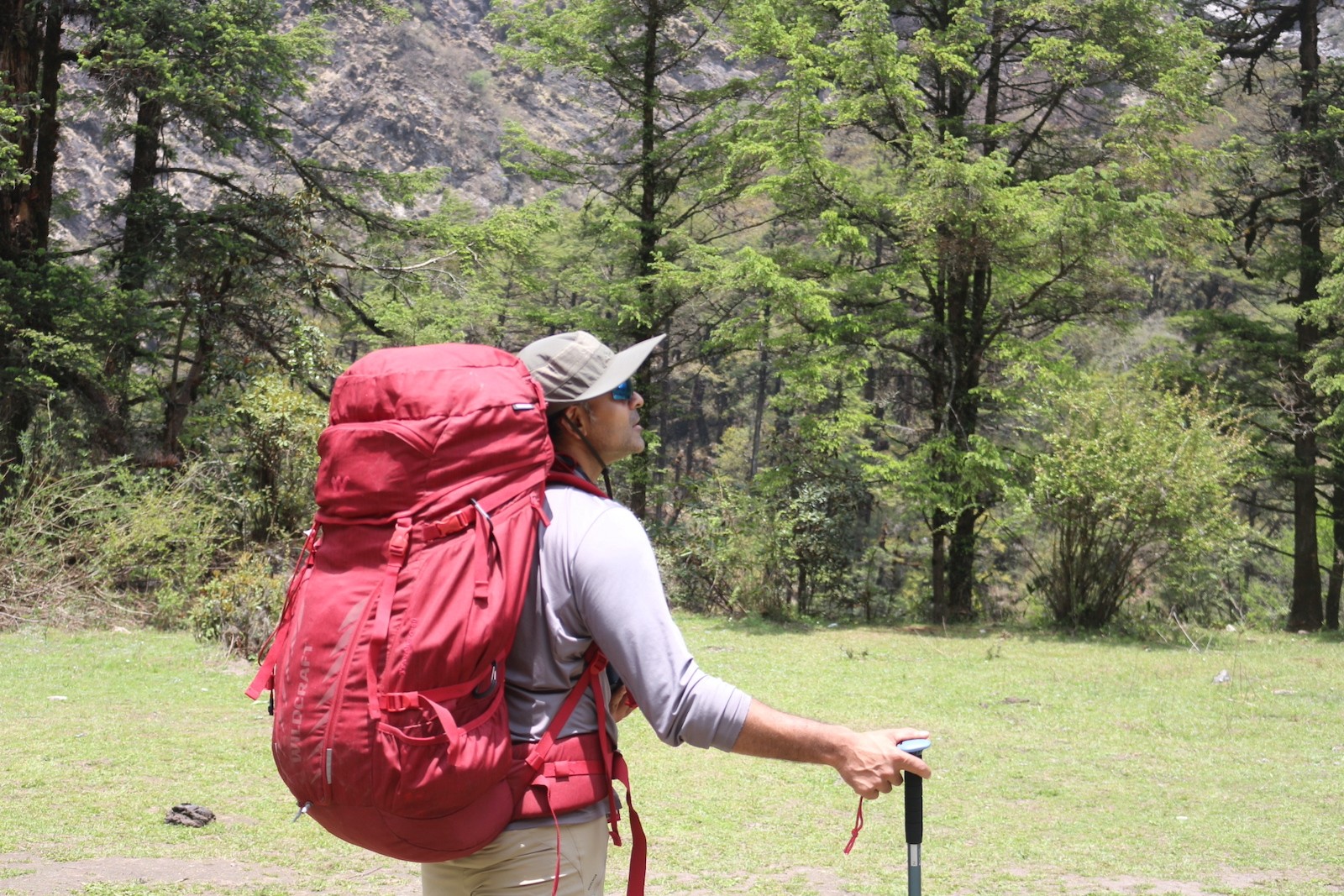  "Lush green Langtang Valley during the monsoon season with Kyanjin Gompa, mist-covered Himalayan peaks, vibrant alpine meadows, and fewer trekkers on the trail."  