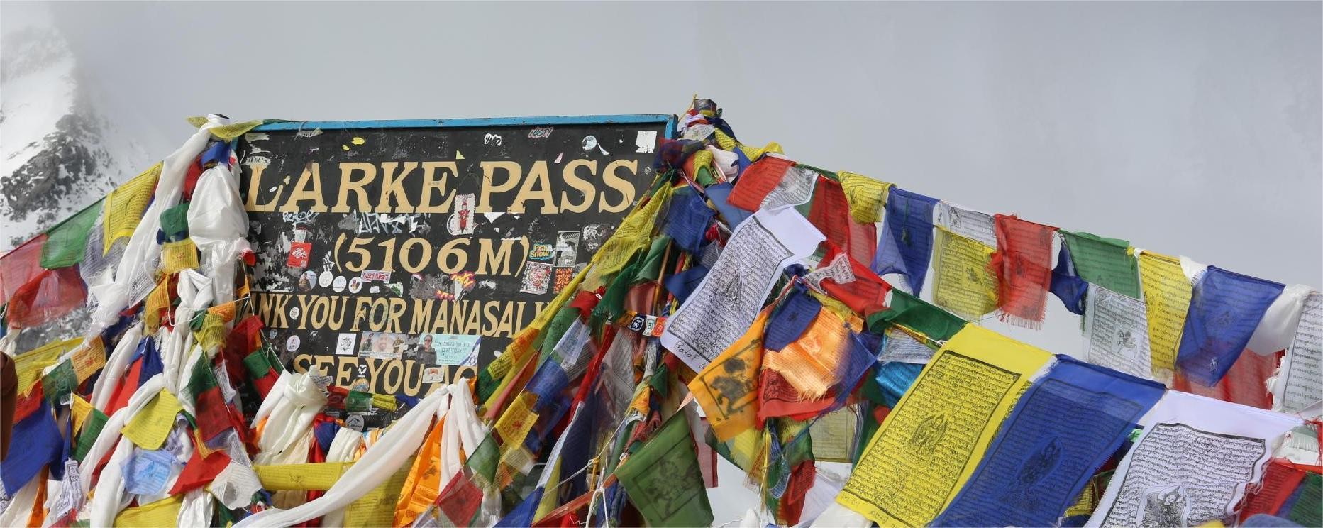 Larke Pass (Larkya La) at 5,106m on Manaslu Circuit Trek in Nepal showing high mountain pass, snow covered trail and panoramic Himalayan views in the Manaslu region
