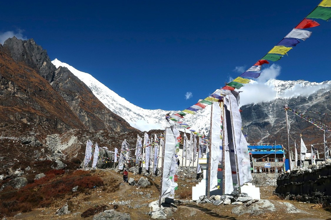 Kyanjin Gompa Buddhist monastery surrounded by snow-capped Himalayan peaks in Langtang Valley, a sacred spiritual and cultural landmark on the Langtang Valley Trek, Nepal.