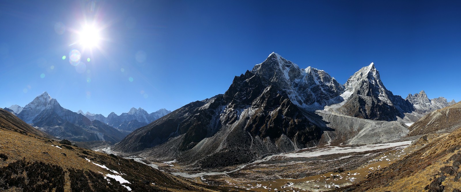 "Panoramic view from Dingboche featuring Ama Dablam, Lhotse, Makalu, Island Peak, and the snow-covered Himalayan mountains along the Everest Base Camp Trek in Nepal."