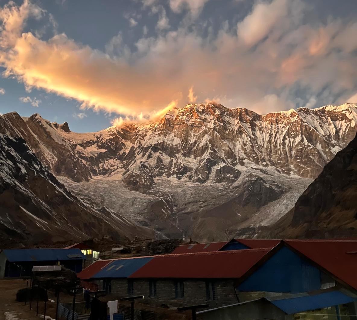 Annapurna Base Camp bathed in golden sunrise light with the majestic Annapurna I peak towering above the Himalayas in Nepal.
