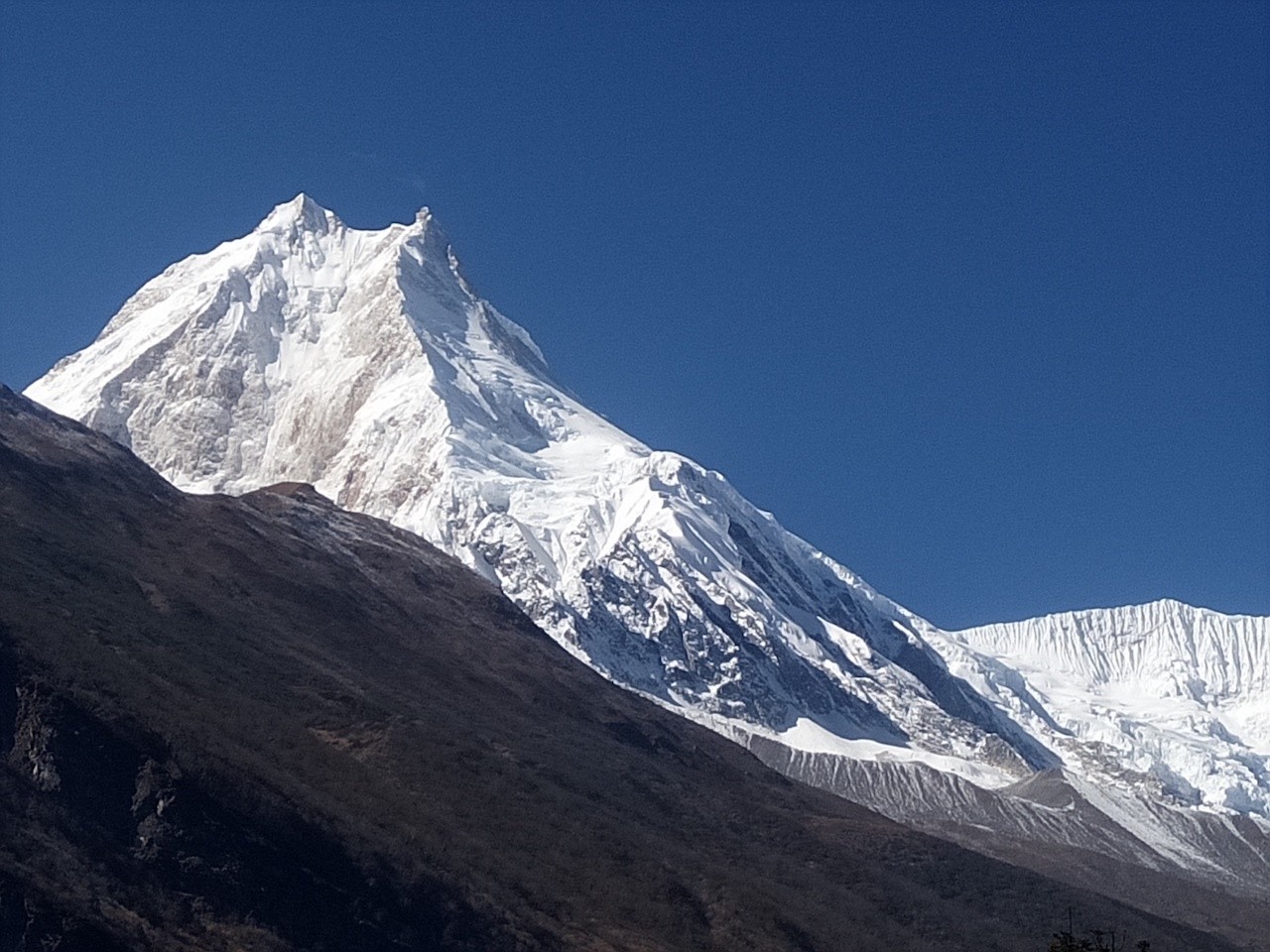 Close-up view of Mount Manaslu surrounded by rugged Himalayan peaks.