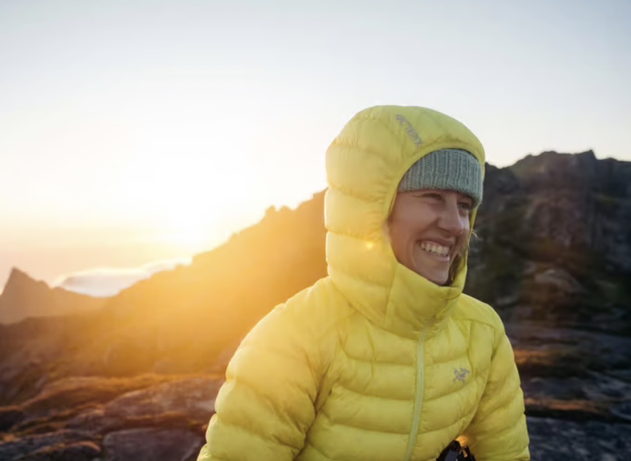 Trekker wearing a warm down jacket inside a High Camp teahouse on the Mardi Himal Trek in Nepal.