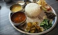 Traditional Nepali dal bhat meal served at a mountain teahouse in the Himalayas, providing high-energy food for trekkers during long trekking days in Nepal.