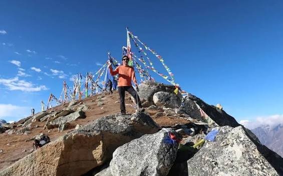 Trekkers climbing Tserko Ri (4,984 m / 16,350 ft) above Kyanjin Gompa in Langtang Valley, Nepal, with sweeping views of Langtang Lirung, glaciers, snow-covered Himalayan peaks, and rugged alpine terrain." 