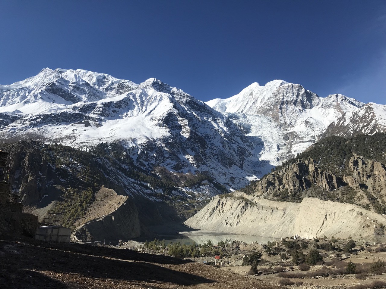 Crystal-clear Himalayan mountain panorama in October featuring snow-capped Annapurna peaks beneath a deep blue sky, with exceptional visibility and vibrant post-monsoon landscapes.