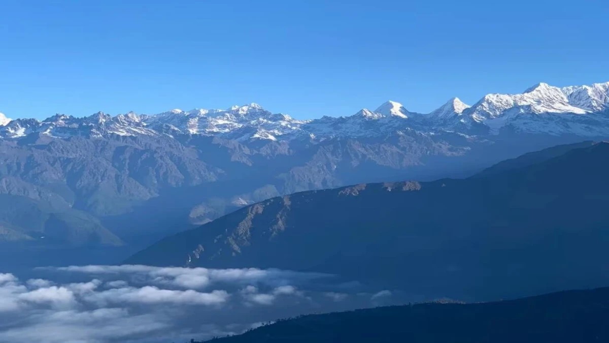 Pikey Peak viewpoint with panoramic views of Mount Everest, Numbur, and the eastern Himalayas at sunrise, surrounded by colorful prayer flags and alpine landscapes in Nepal.