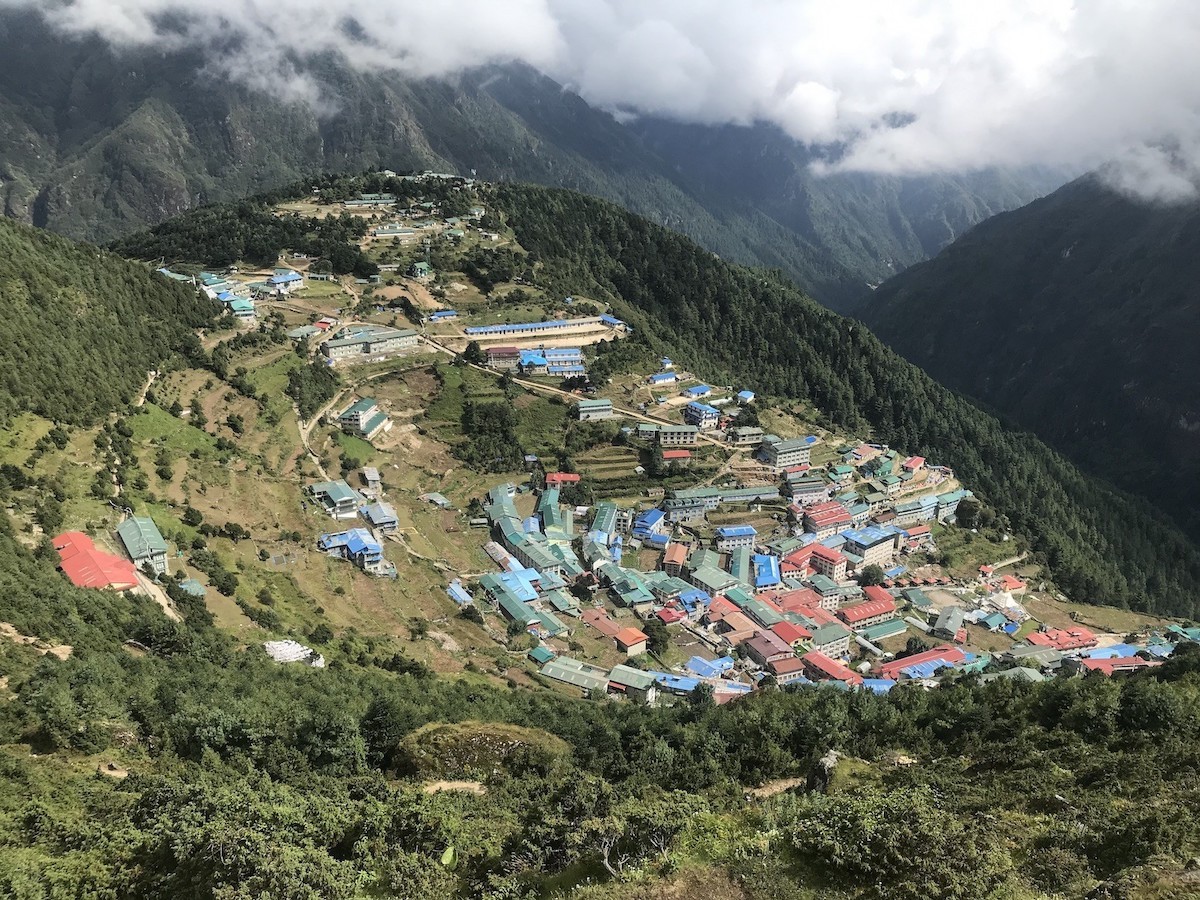 "Namche Bazaar in Nepal's Everest region featuring colorful Sherpa houses, mountain trails, and spectacular Himalayan views during the Everest Base Camp Trek."