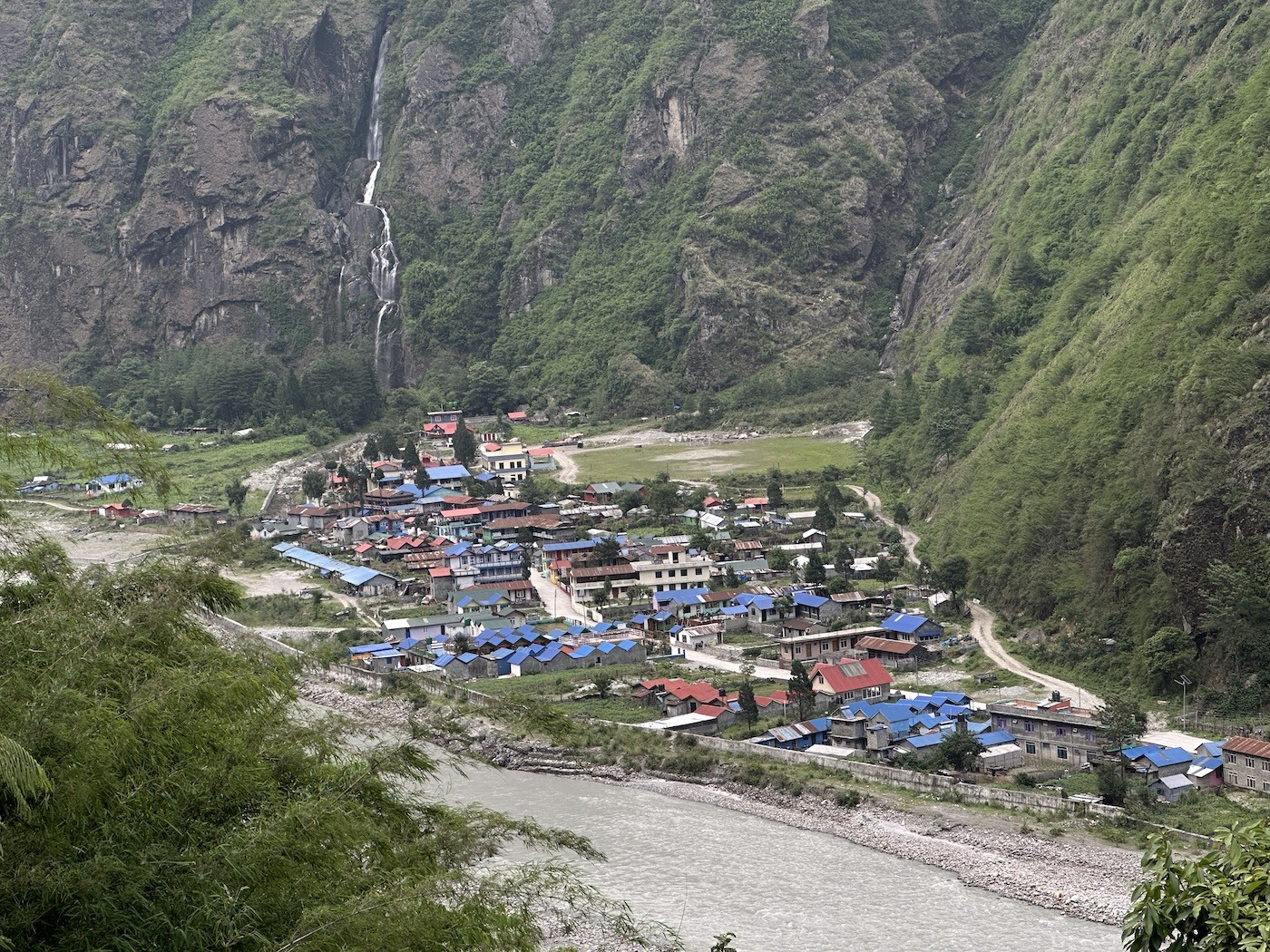 Tal Village on the Annapurna Circuit Trek featuring traditional stone houses, the Marsyangdi River, dramatic waterfalls, towering cliffs, lush forests, and spectacular Himalayan scenery in Nepal.