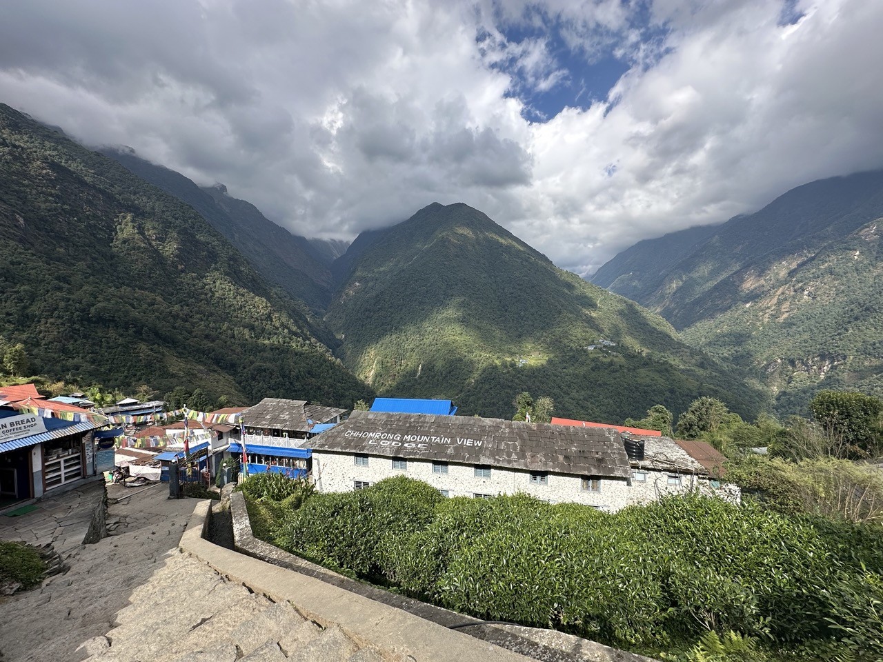 Traditional Chhomrong village nestled on a hillside with stone houses, terraced fields, and stunning views of Annapurna South and Machhapuchhre along the Annapurna Base Camp Trek via Poon Hill.