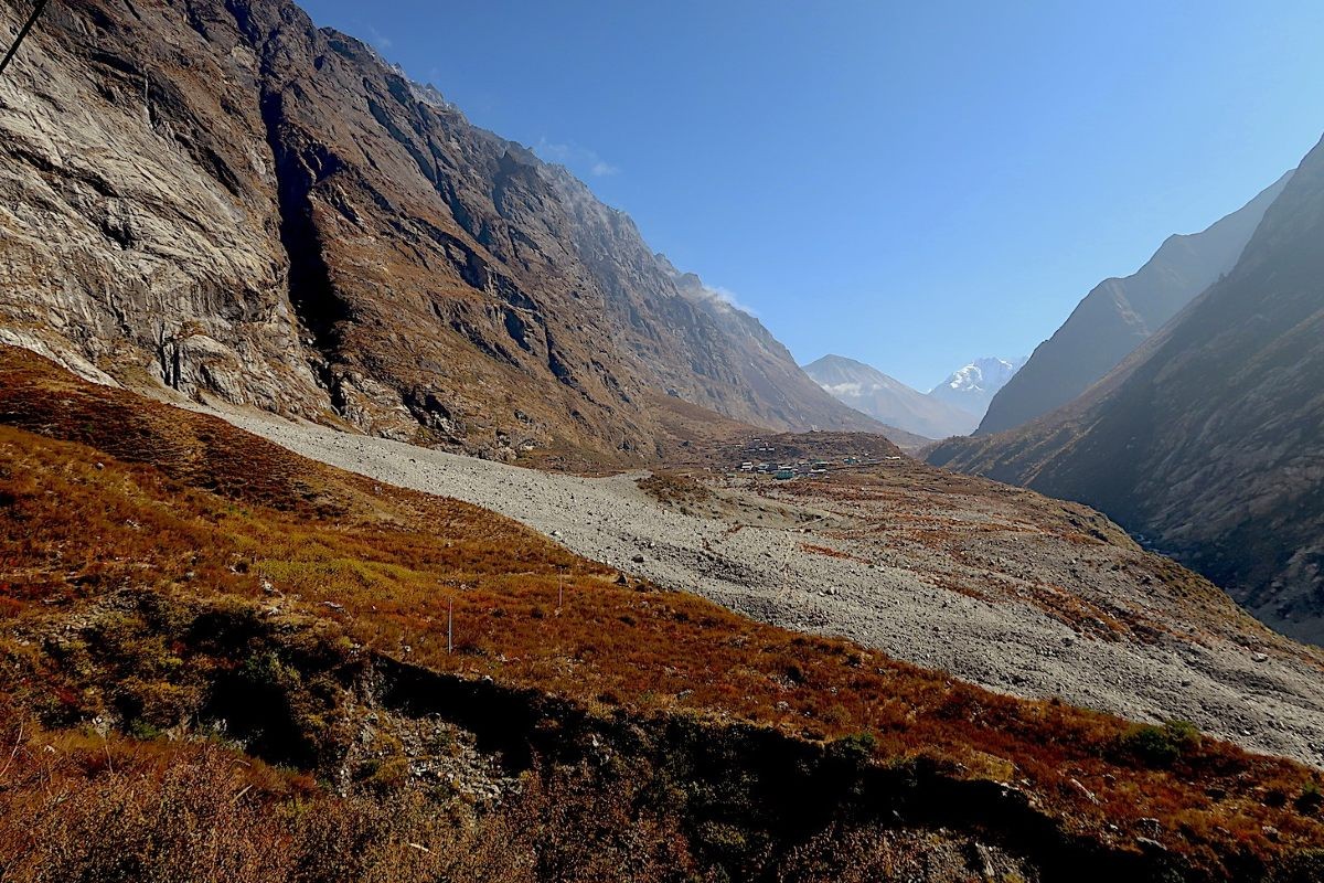 Avalanche debris covering the old Langtang Village after the 2015 Nepal earthquake, with the rebuilt Langtang Village now located in a safer area of Langtang Valley.
