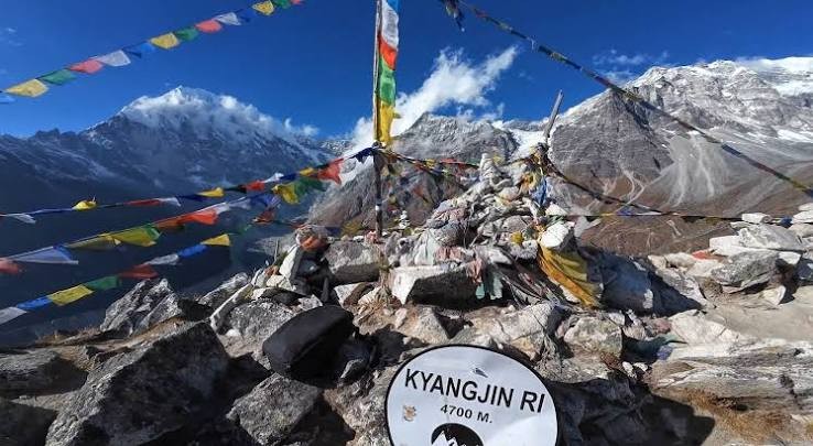 "Trekkers hiking to Kyanjin Ri (4,773 m / 15,663 ft) above Kyanjin Gompa in Langtang Valley, Nepal, with panoramic views of Langtang Lirung, snow-capped Himalayan peaks, glaciers, and alpine landscapes." 