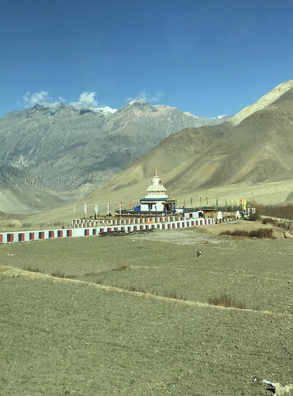 Alpine desert landscape in Mustang with Buddhist stupa and barren Himalayan mountains Nepal