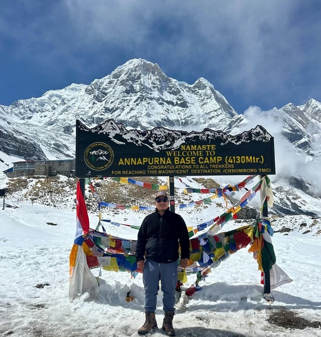 Annapurna Base Camp in winter covered with snow, surrounded by snow-capped Himalayan peaks and a frozen alpine landscape.