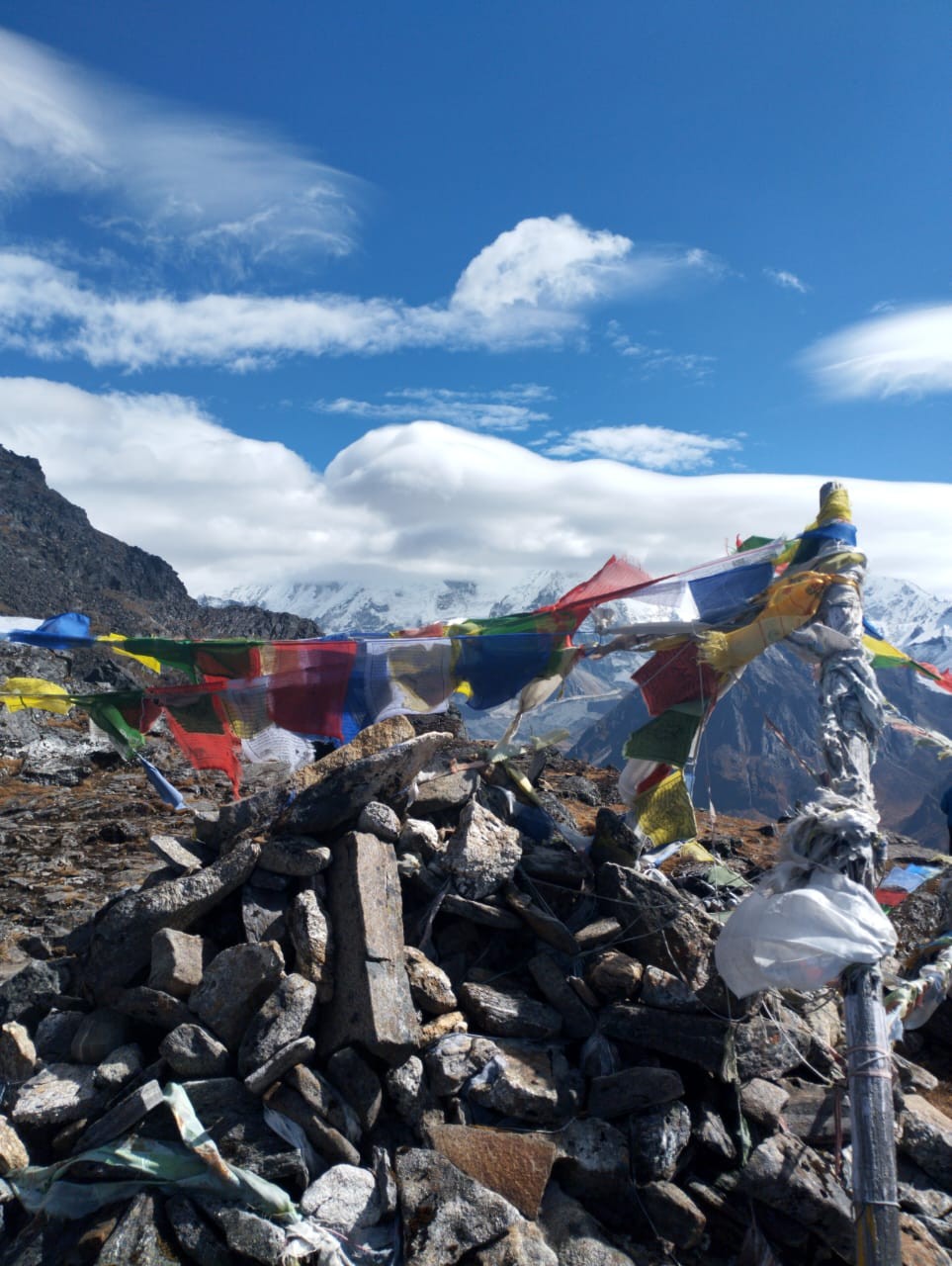 Sele La Pass on the Kanchenjunga Base Camp Trek, featuring colourful prayer flags, rugged mountain trails, and spectacular panoramic views of snow-capped Himalayan peaks.