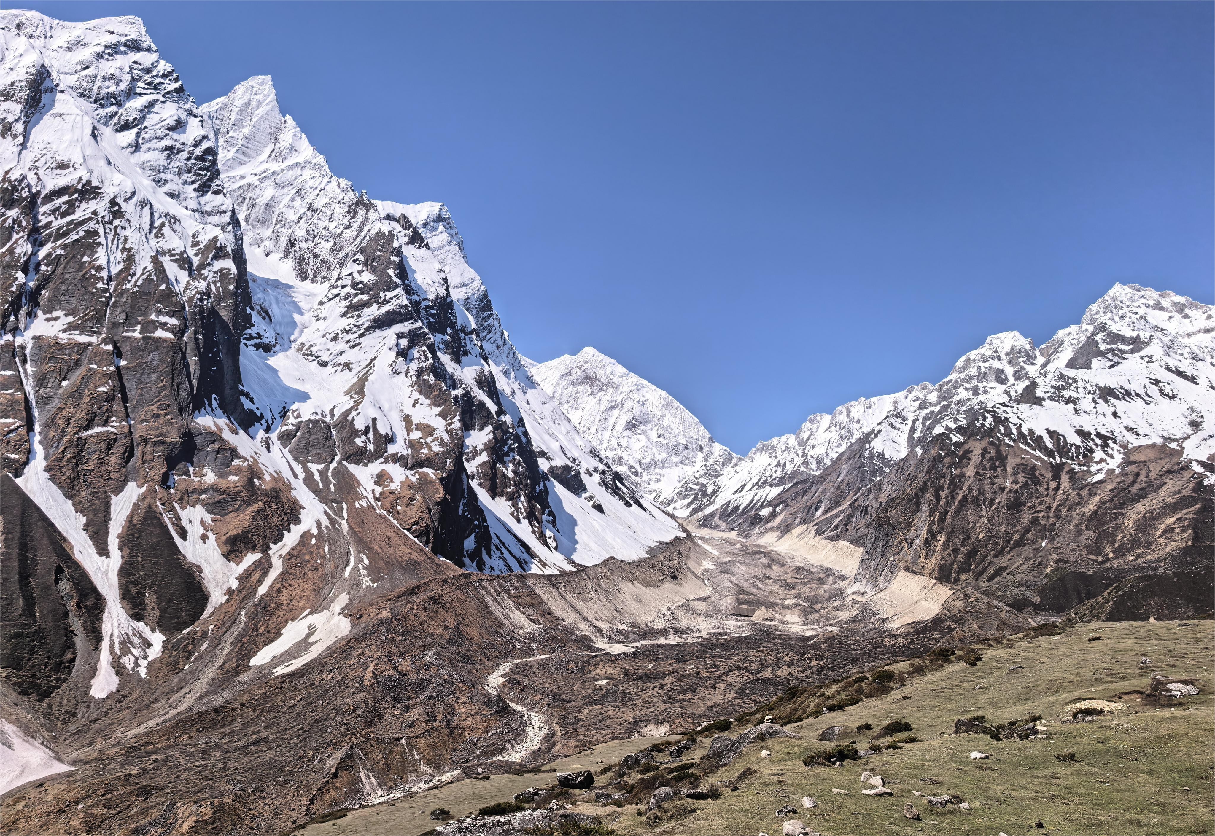 Alpine trekking route to Larke Pass in Manaslu Circuit Nepal with remote high mountain scenery and snow covered Himalayas