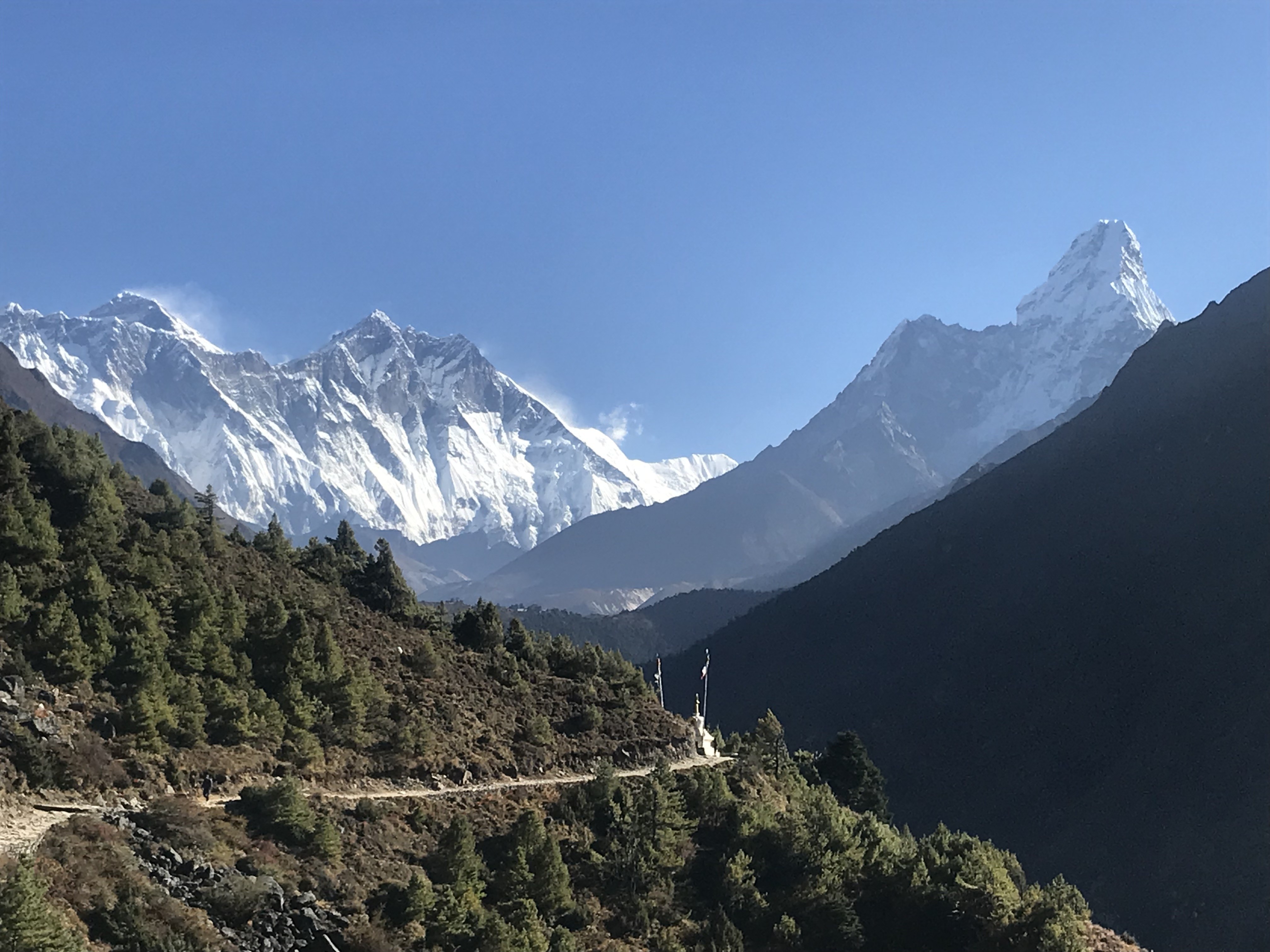 Scenic trail from Namche Bazaar to Tengboche in October with golden autumn forests, Mount Ama Dablam, and clear Himalayan mountain views.