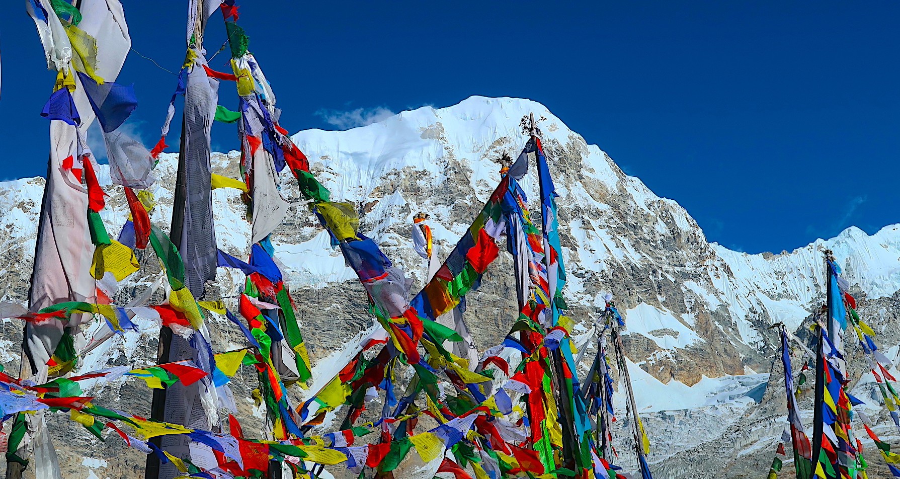 Crystal-clear mountain view during the Langtang Valley Trek in autumn, showcasing snow-capped Himalayan peaks under a deep blue sky in Langtang National Park, Nepal.
