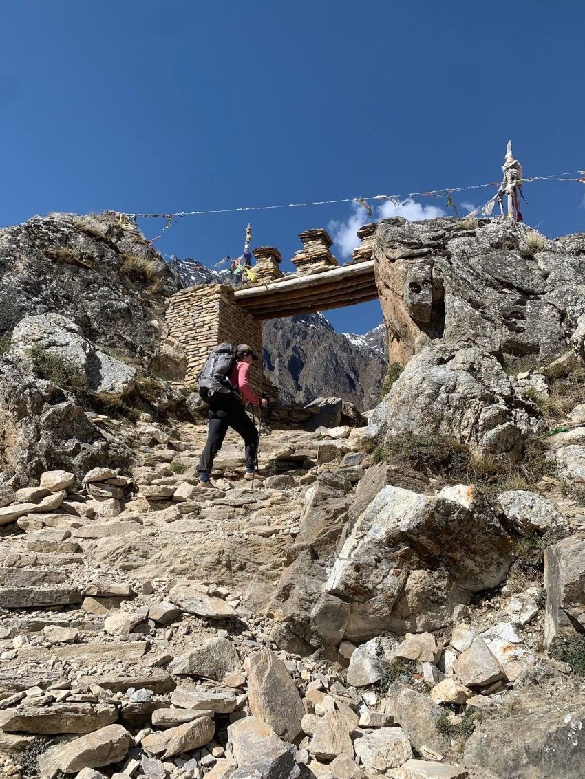 Traditional entrance gate to Nar Village on the Nar Phu Trek, featuring Tibetan-style architecture, prayer flags, and dramatic Himalayan mountain scenery.