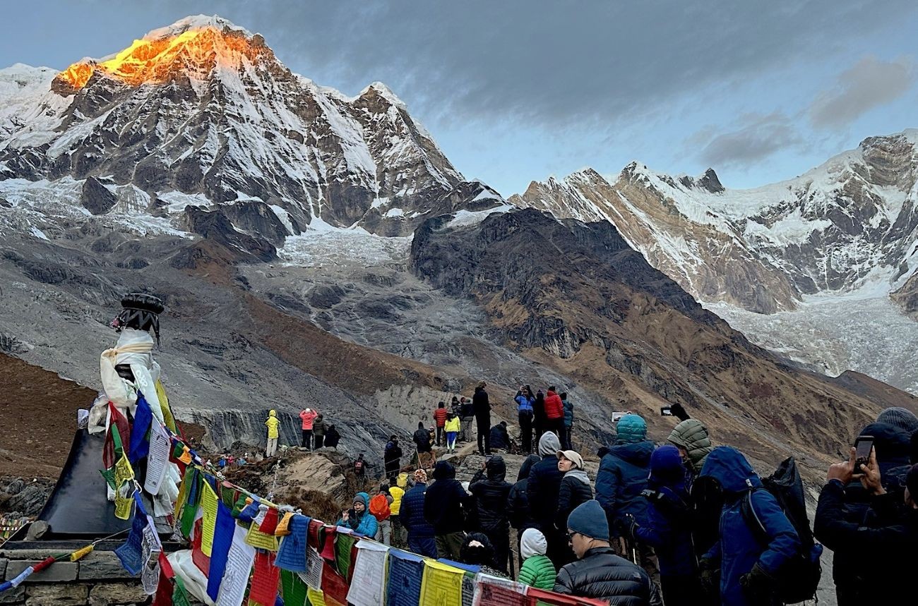 Panoramic viewpoint at Annapurna Base Camp showing wide snow-covered amphitheater of Himalayan peaks including Annapurna I, Machapuchare, Hiunchuli, and surrounding glaciers.