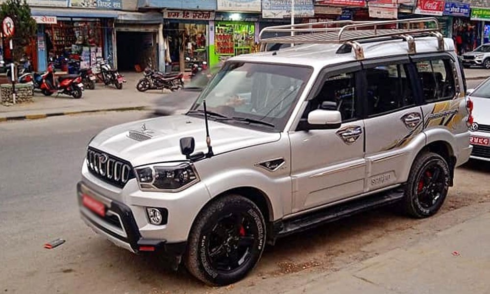 Four-wheel-drive jeep traveling along a rugged mountain road in Nepal, carrying trekkers through scenic valleys, rivers, and Himalayan landscapes.