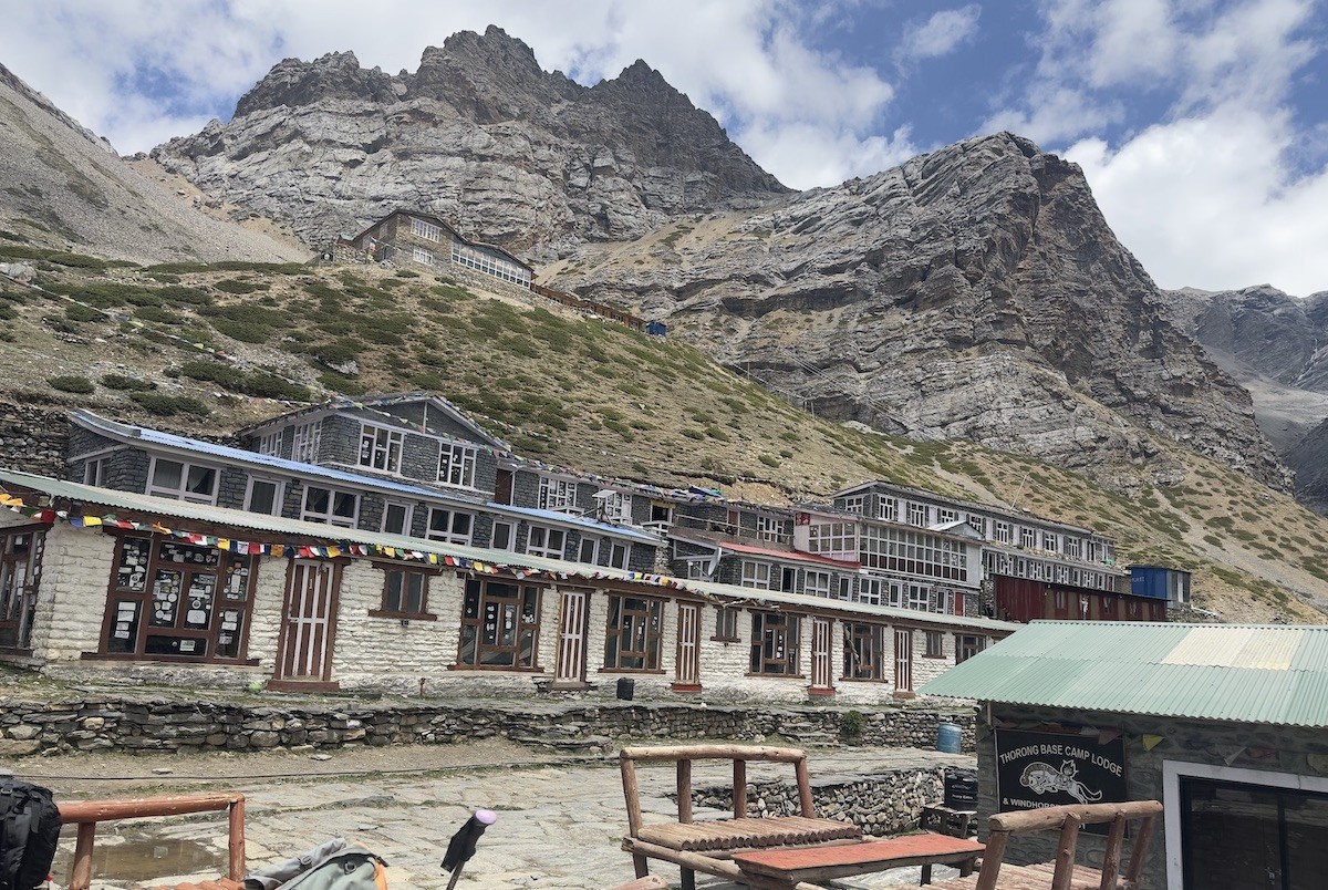 "Thorong Phedi on the Annapurna Circuit Trek featuring mountain lodges, rugged alpine terrain, trekkers preparing for the ascent to Thorong La Pass, and snow-covered Himalayan peaks in Nepal."