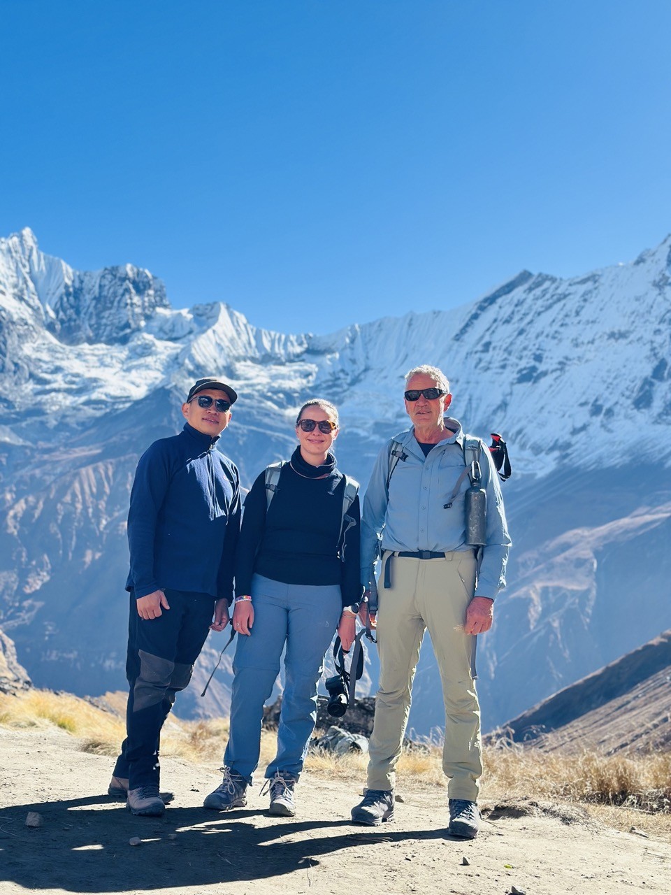 Trekkers walking on a dry, well-maintained trail during the Annapurna Base Camp Trek in November, with clear mountain views and stable trekking conditions.