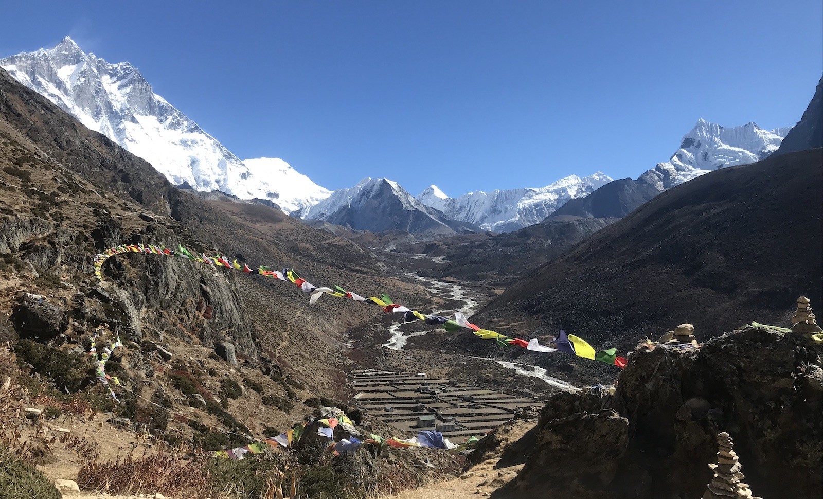 Dingboche Village surrounded by snow-capped Himalayan peaks during an acclimatization day on the Everest Base Camp Trek in Nepal.