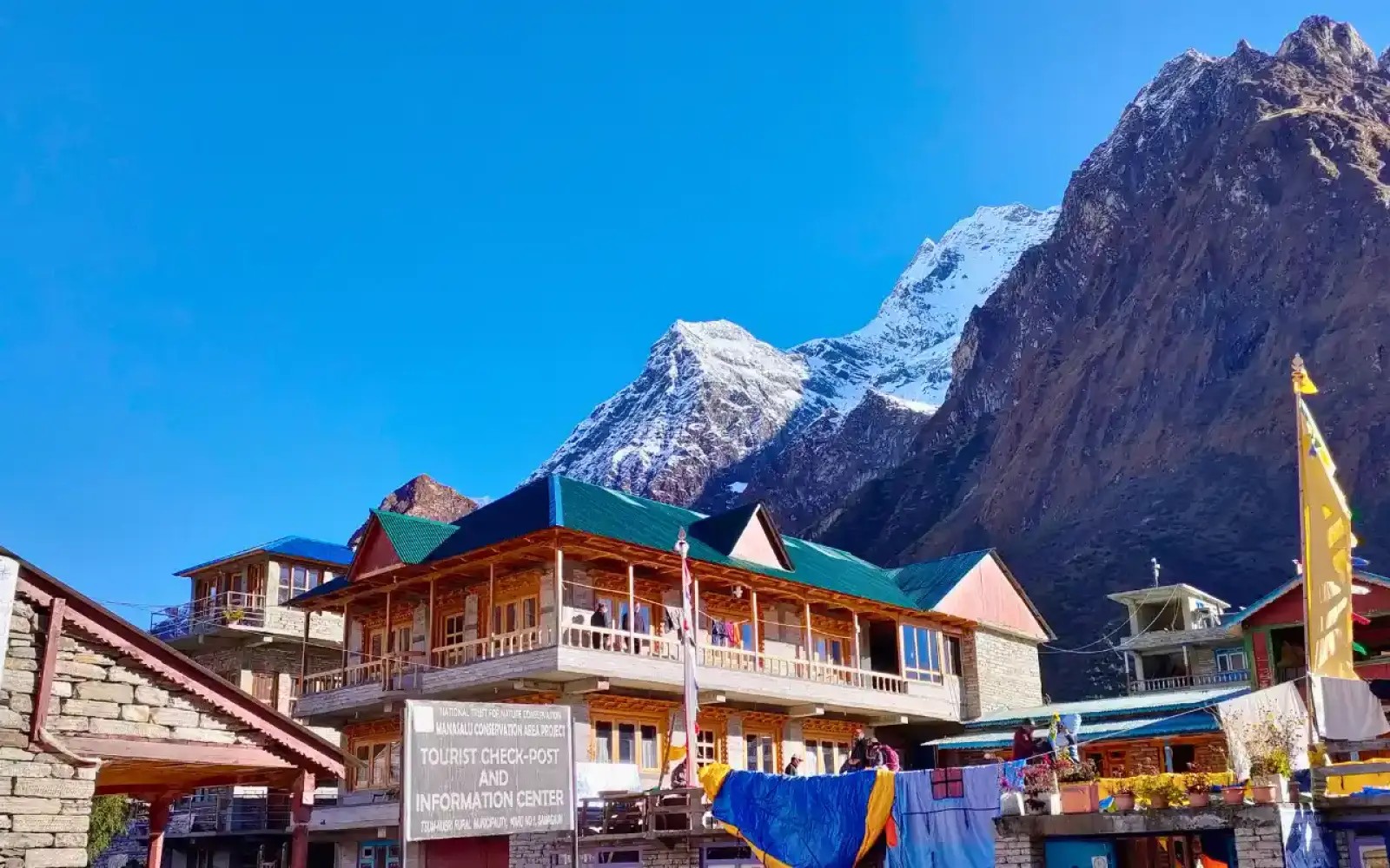 Simple trekking lodge on Manaslu route with mountain backdrop