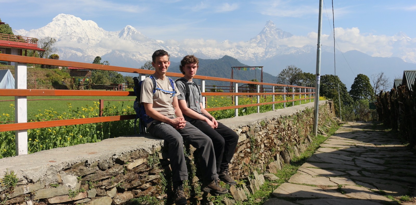 Trekkers in light, breathable layers hiking through the green landscapes of the Mardi Himal Trek in Nepal.