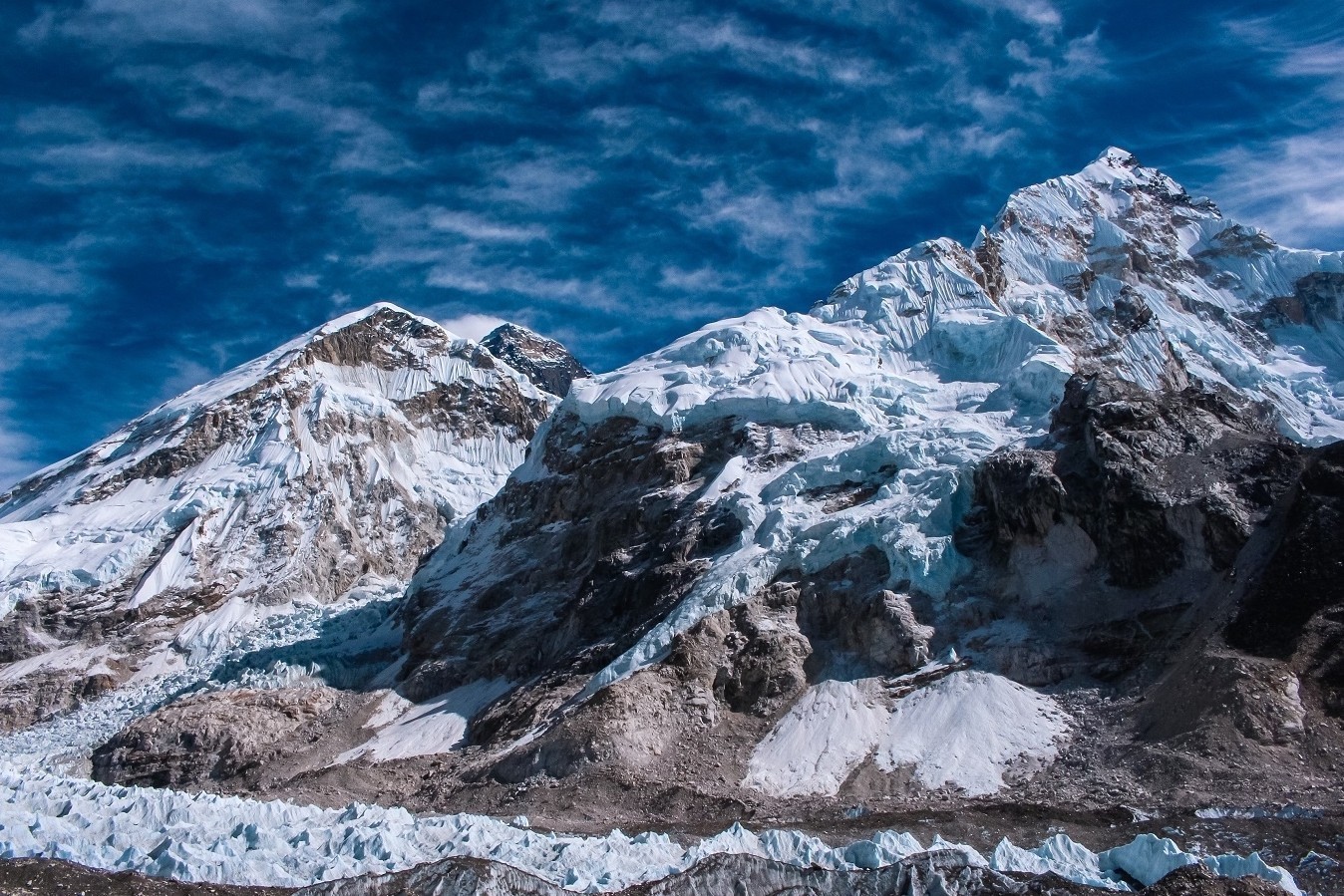 "Khumbu Icefall near Everest Base Camp featuring towering blue ice seracs, deep crevasses, and the dramatic Khumbu Glacier in Nepal's Everest region." 