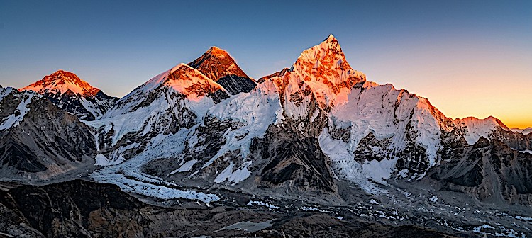 Golden sunrise over Mount Everest, Nuptse, and Lhotse viewed from Kala Patthar (5,545 m), with glowing Himalayan peaks and the Khumbu Glacier below.