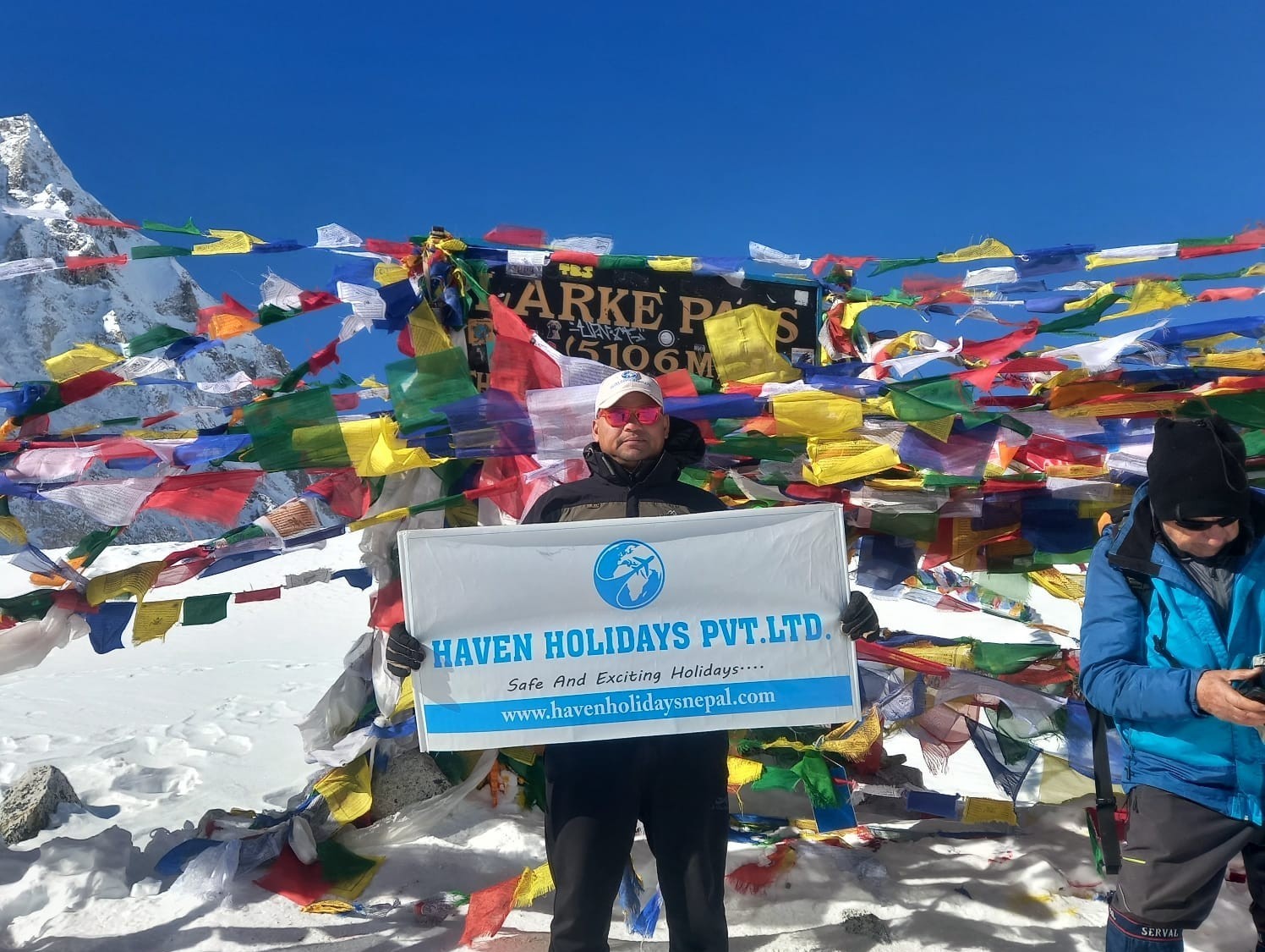 Colourful prayer flags and snowy Himalayan peaks