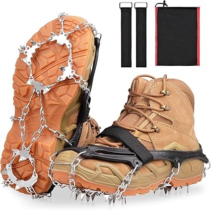 Trekker wearing sturdy waterproof trekking boots with microspikes, walking confidently across icy trails and rocky terrain on the Manaslu Circuit Trek, surrounded by snow-covered Himalayan peaks.