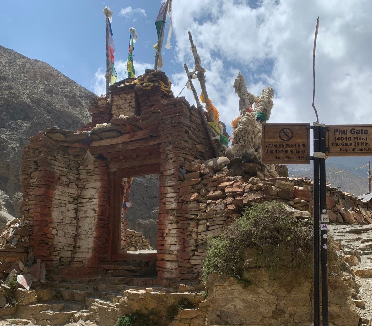 Ancient Phu Gate marking the entrance to Phu Village in the remote Nar Phu Valley of Nepal, surrounded by rugged Himalayan mountains.