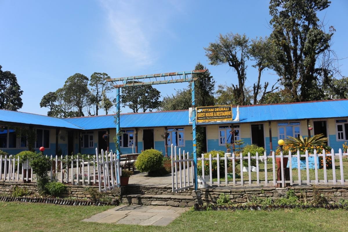 Pitam Deurali with traditional lodges and Himalayan mountain views on the Mardi Himal Trek in Nepal.