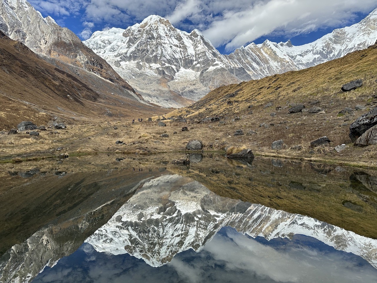 Reflection lake on the way to ABC – a peaceful Himalayan gem where the mountains and sky create a perfect mirror image.