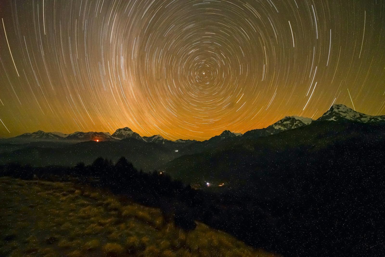 Brilliant star-filled night sky above Poon Hill with the silhouettes of the Annapurna and Dhaulagiri ranges, creating a peaceful Himalayan landscape under the Milky Way.