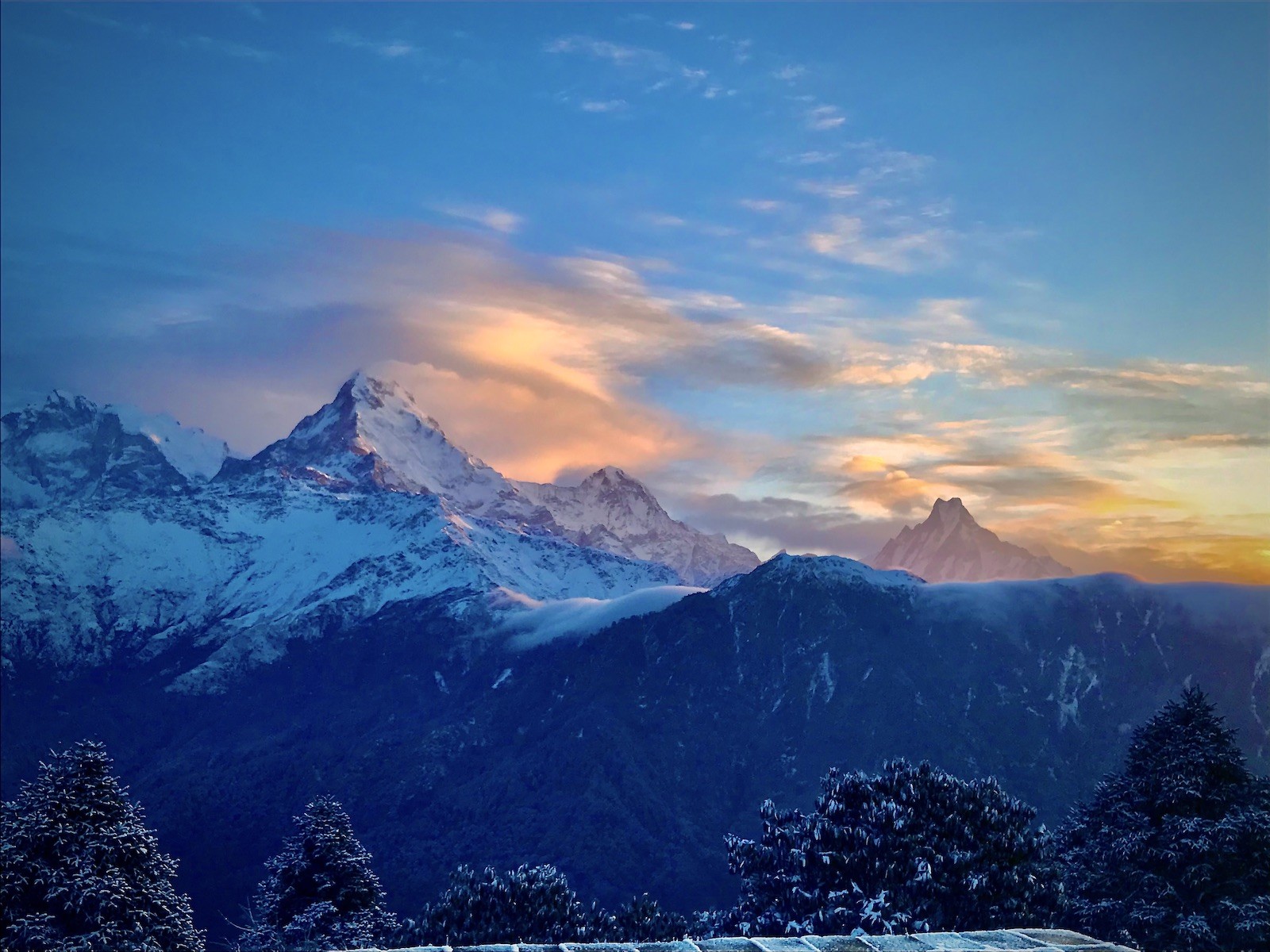 Light snowfall on the Poon Hill Trek in November with snow-dusted trails, Himalayan mountains, and trekkers enjoying clear autumn weather in Nepal.