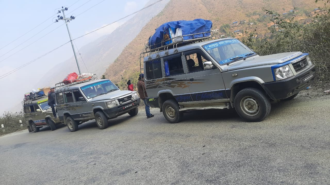 4WD jeep driving on the rugged mountain road to Salleri and Surke, offering an overland alternative to the Lukla flight for the Everest Base Camp Trek, Nepal.